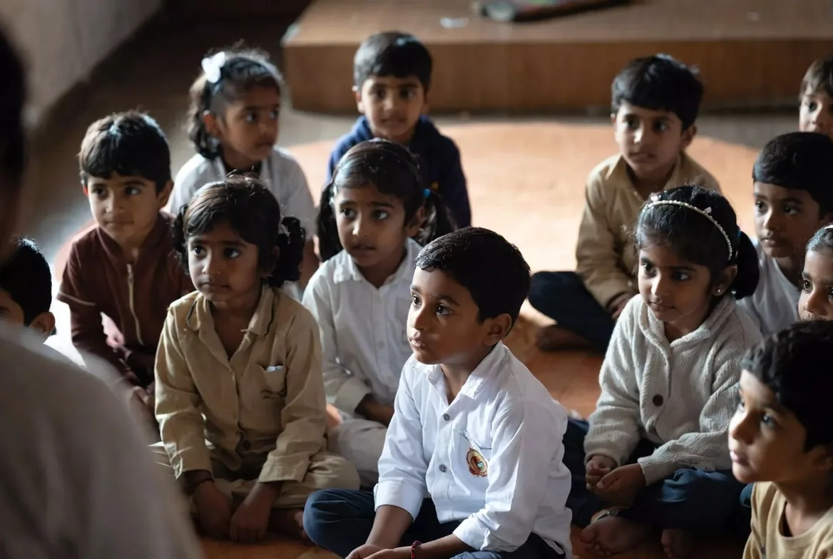 A group of children sitting on the floor listening together