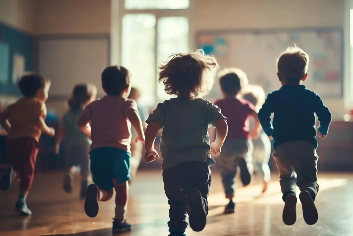 Young children moving together through a bright indoor play space