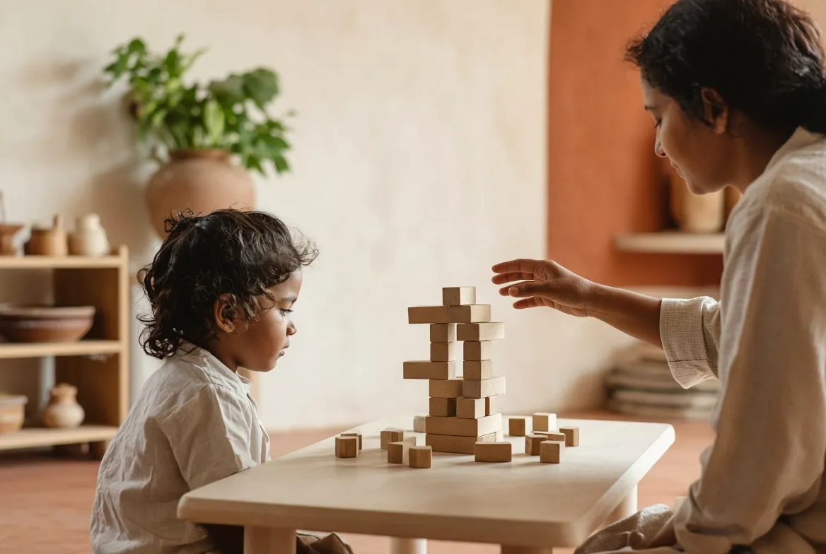A teacher pointing to a child’s block tower to extend the idea